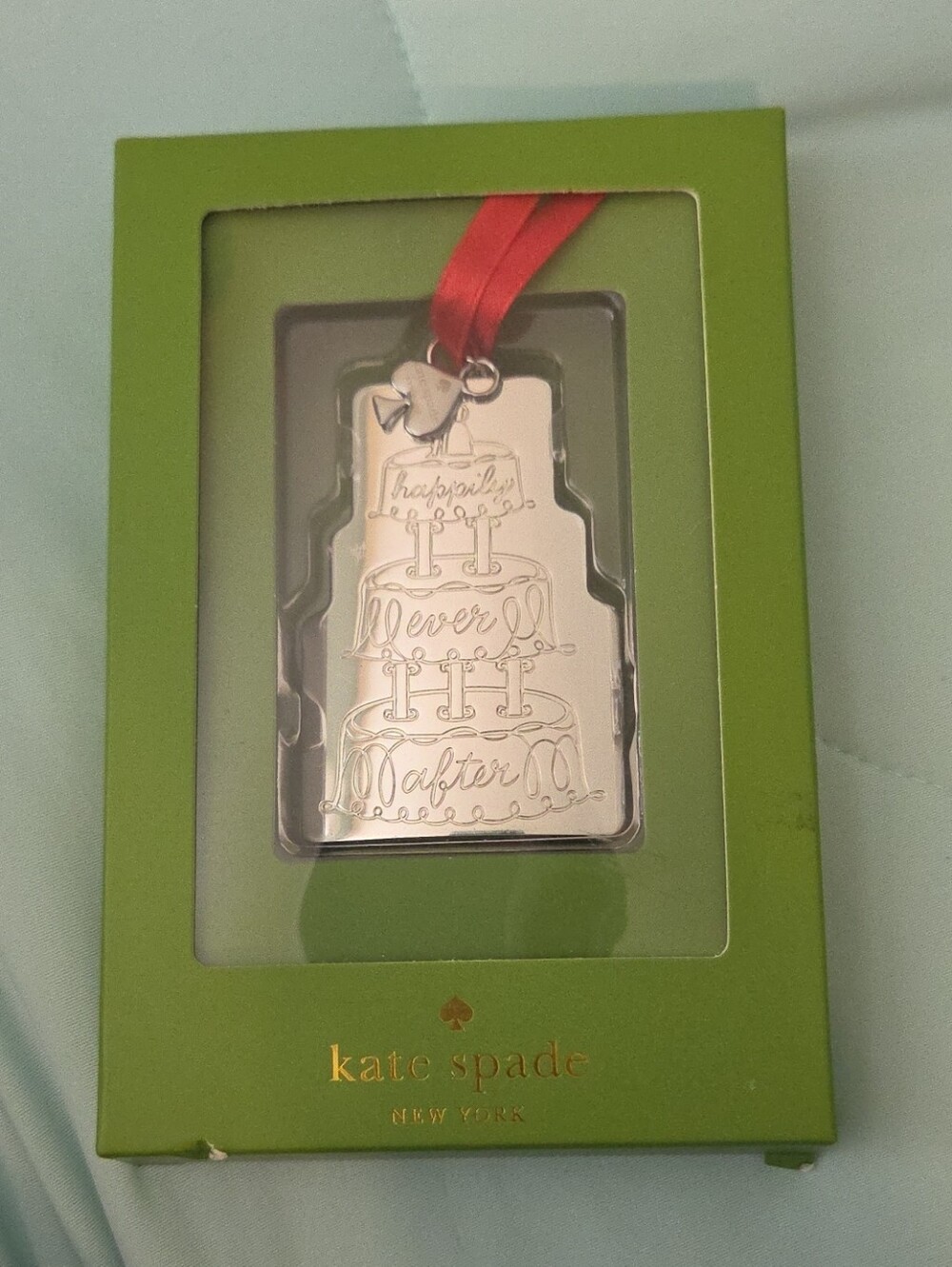 kate spade silver ornament with red ribbon